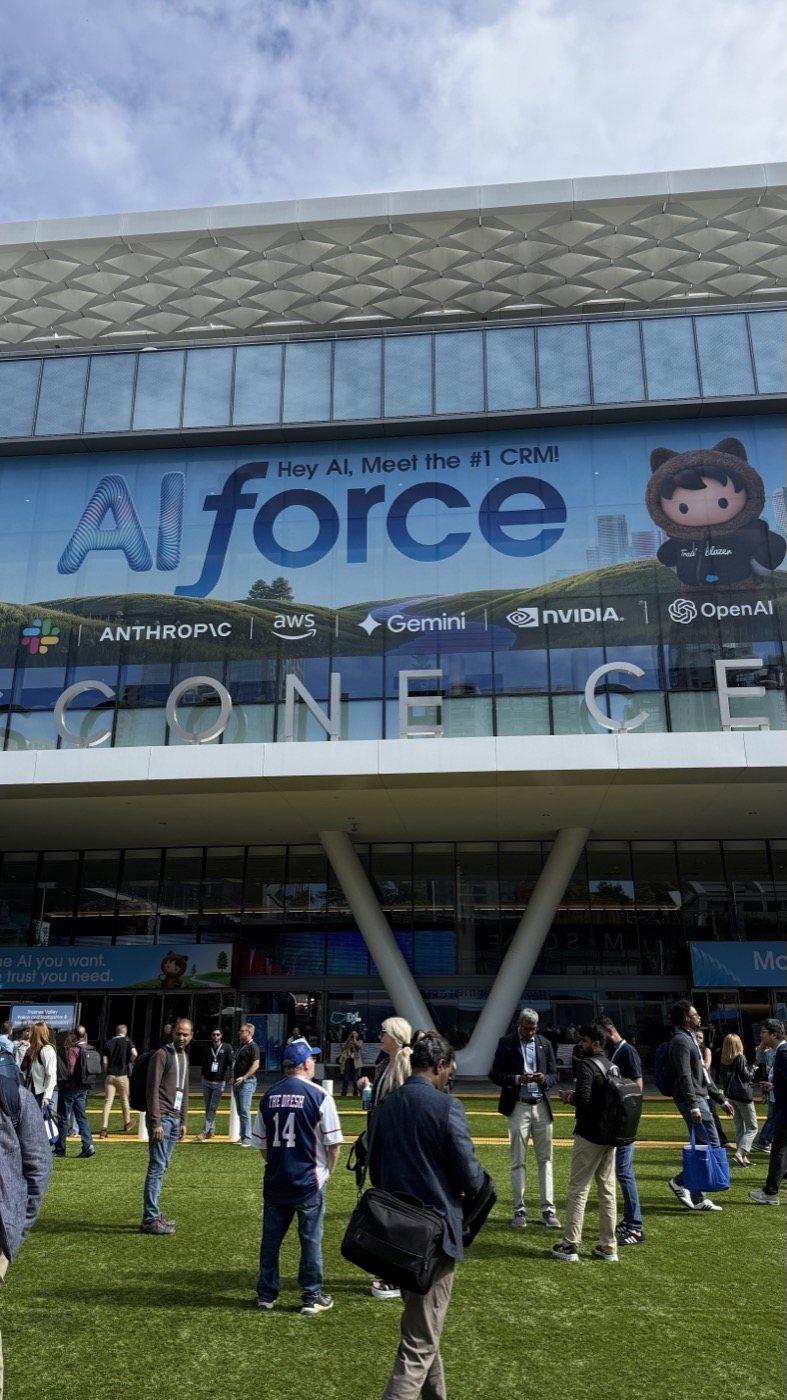 The AIforce banner across the front of Moscone, carrying the logos of Anthropic, Gemini, NVIDIA and OpenAI, crowds on the lawn below.