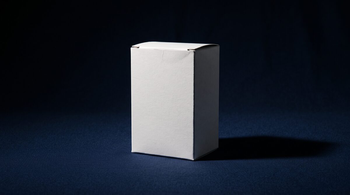 A completely blank white carton on deep navy, with no brand name anywhere on it: what status looks like once it stops being about the logo.
